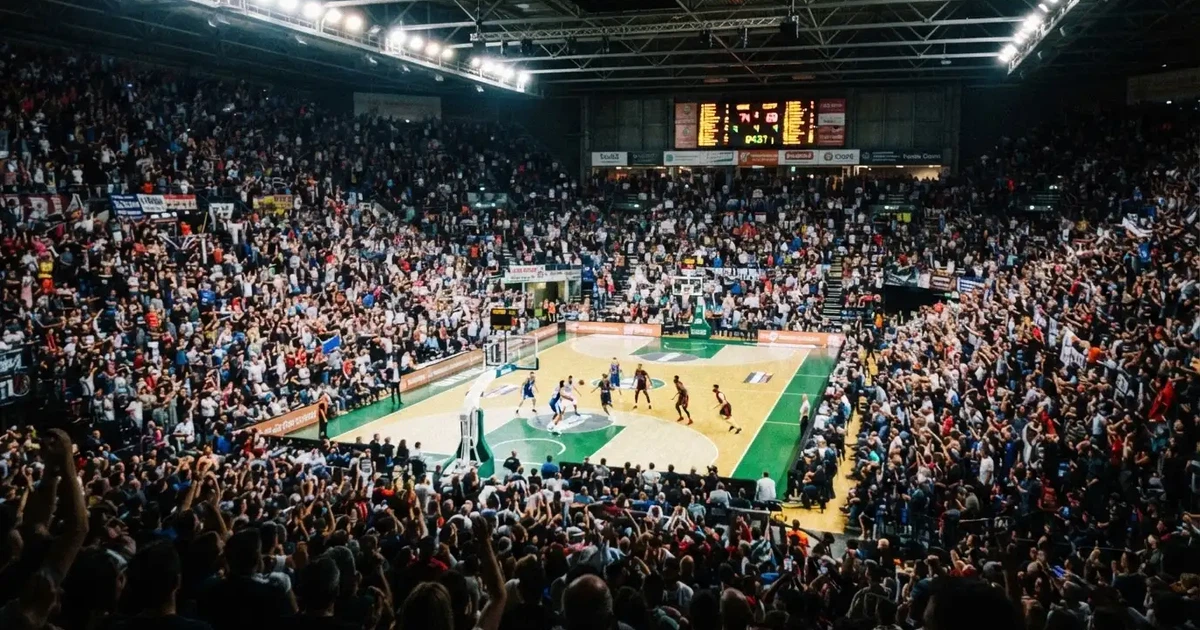 A packed sports hall under floodlights photographed from a long way off